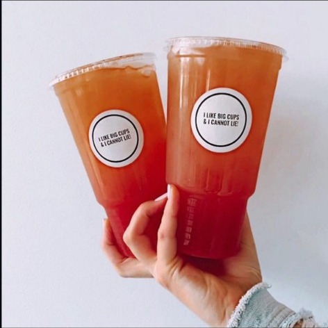 Two big loaded teas in 'I like big cups & I cannot lie' cups, layered orange to red.